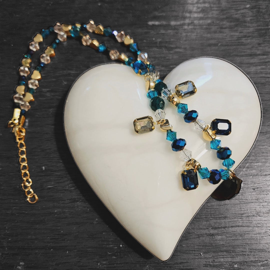 Necklace, blue and green gem charms, gold tone beads, dark blue crystal teardrop charm